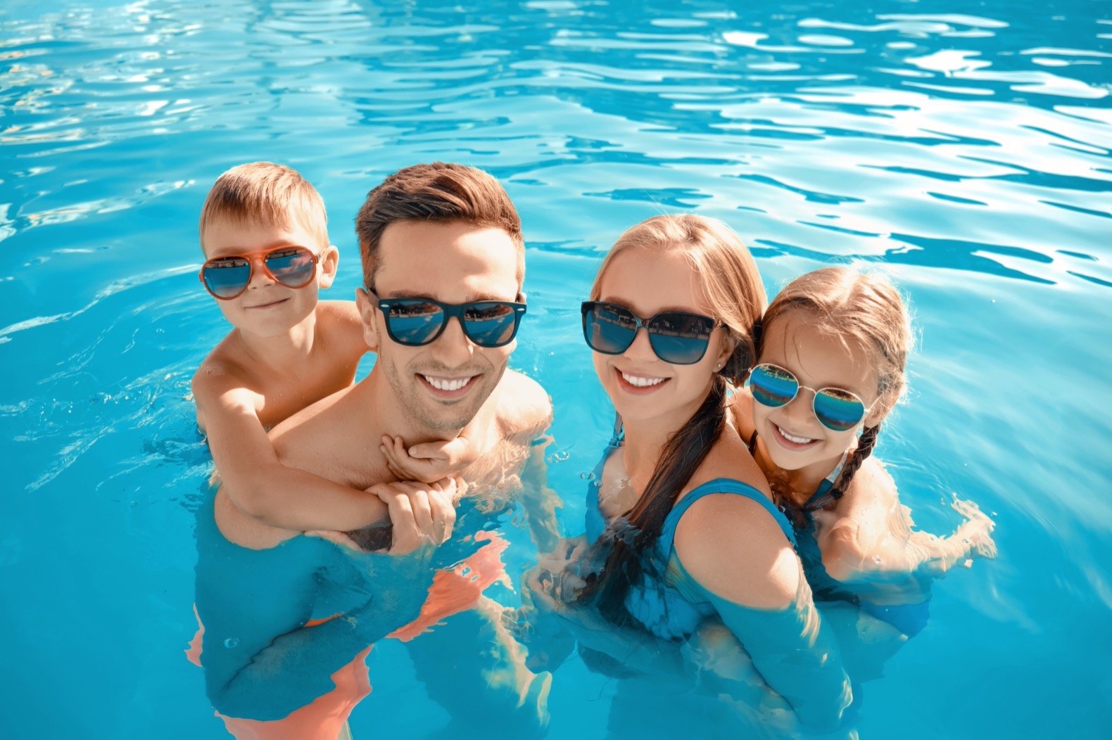 Family In a Pool with Sunglasses