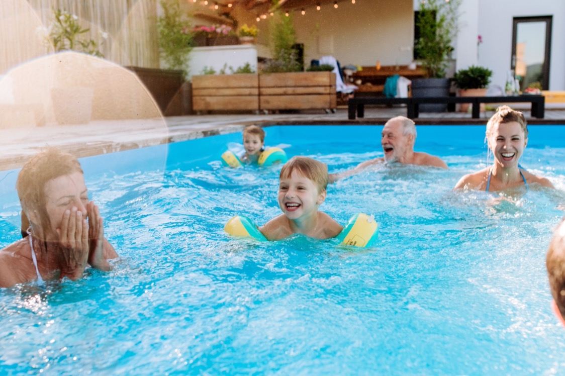 Family In a Pool Swimming Together