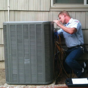 Technician working on an air conditioning unit