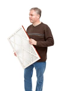 man-changing-out-air-filter-to-boost-ac-efficiency