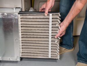 dirty-air-filter-being-pulled-from-hvac-system