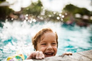 boy-splashing-in-swimming-pool